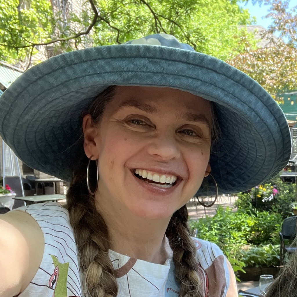 June Melby headshot with big hat