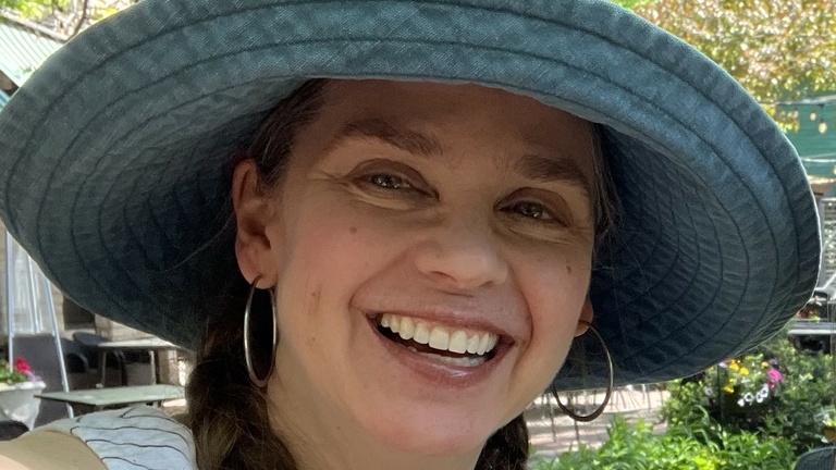 June Melby headshot with big hat